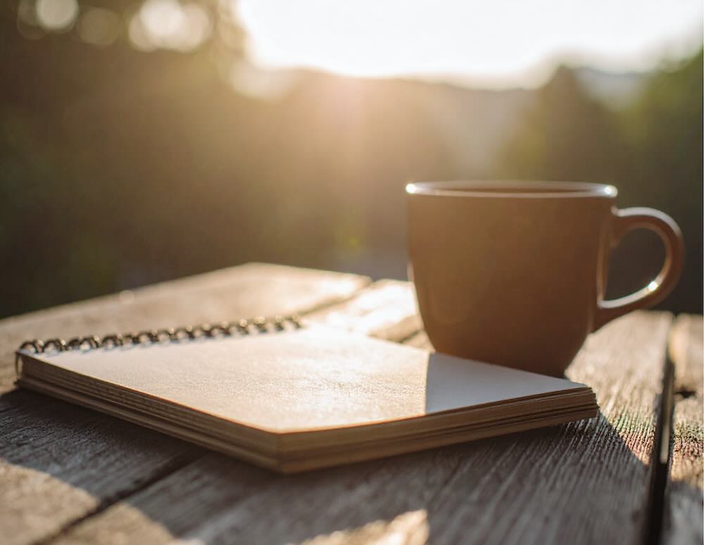 Mug with a notebook on a table