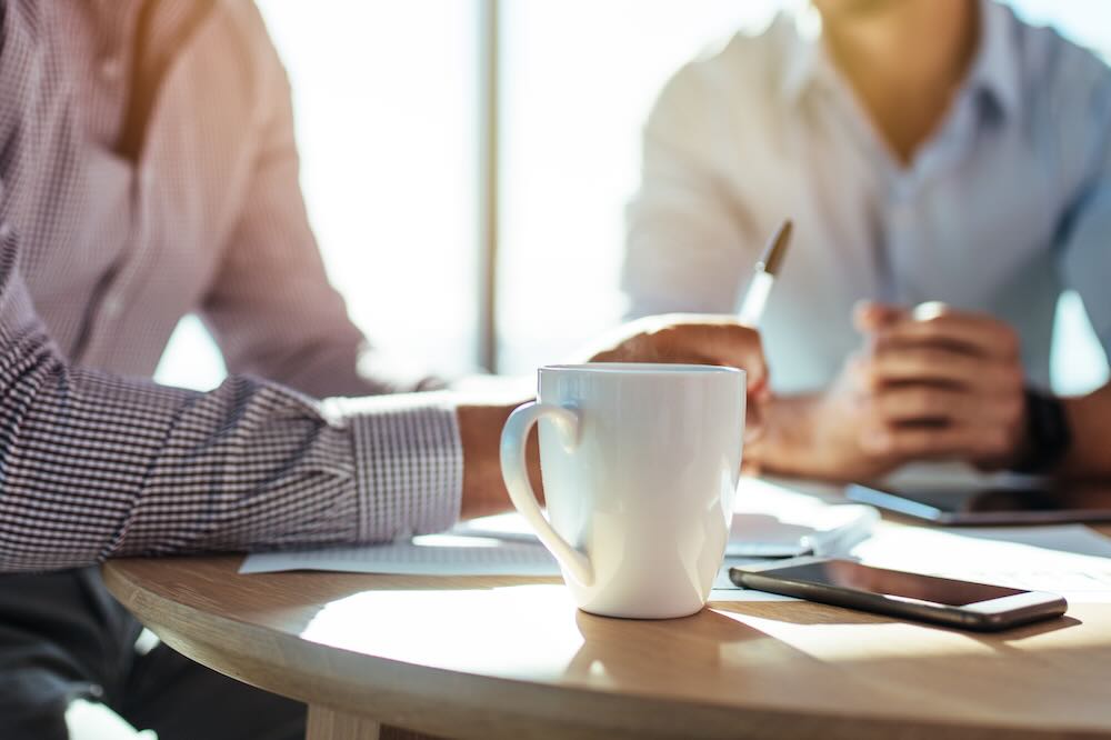Two men in a meeting, a close up shot